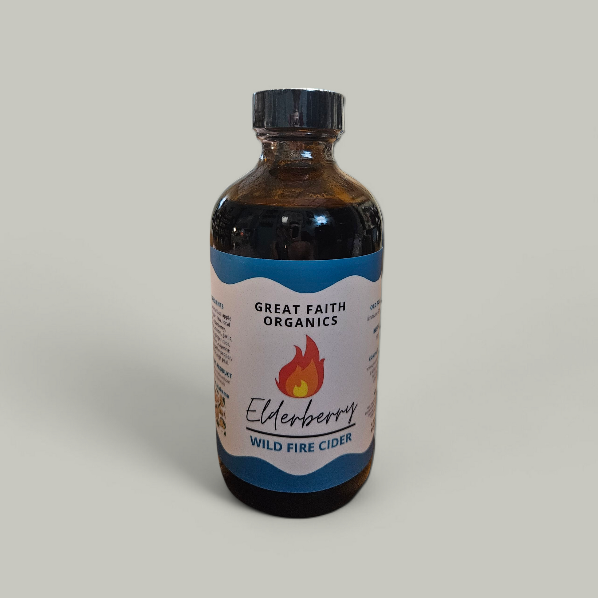 Bottle of Great Faith Organics Elderberry Wild Fire Cider on a gray background
